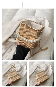 Detail of square straw bucket bag with oversized pearls and gold metal chain strap