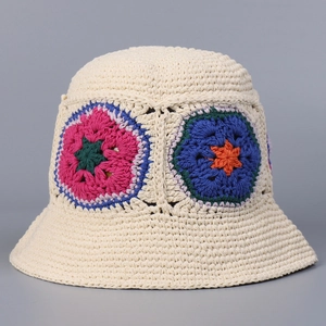 Detailed close-up of handmade crochet bucket hat with colorful floral patterns on cotton