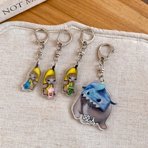 Close-up of four acrylic cat keychains including banana cat and shark cat designs