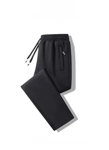 Detail of black jogger pants featuring an elastic drawstring waist and side pocket label
