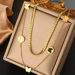 Close-up of double-layered butterfly necklace with Cuban chain in jewelry box