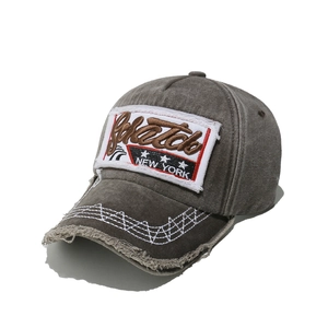 Close-up of vintage washed canvas baseball cap with New York embroidery and frayed brim detail
