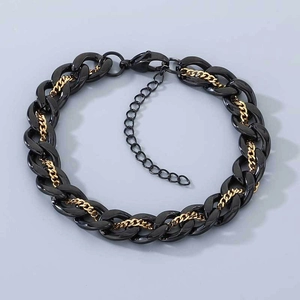 Detail of mixed black resin and gold steel curb chain with lobster clasp and extender