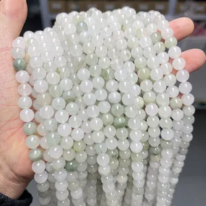 Close-up of natural light green and white jade beads for jewelry making