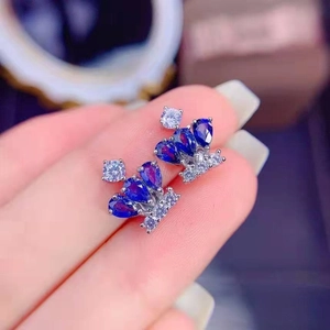 Elegant crown stud earrings with blue sapphire gemstones and sparkling silver accents