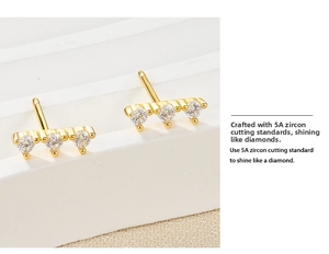 Detailed macro view of S925 silver gold-plated stud earrings with triple 5A cubic zirconia