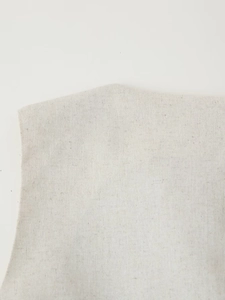 Detailed macro view of the breathable linen texture and fabric of the two-piece set