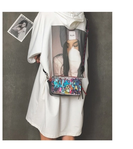 Graffiti print crossbody bag with adjustable wide strap and colorful street art pattern