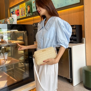 Chic beige herringbone woven crossbody bag with gold hardware for casual summer style