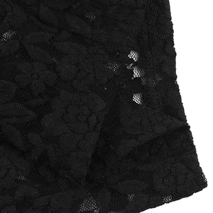 Close-up of intricate black floral lace pattern on a sexy V-neck bodysuit