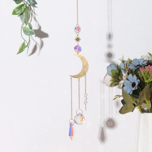 Macro view of rainbow crystal prisms and moon star metallic components on garden suncatcher