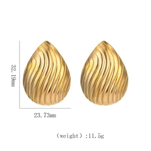 Detail view of 18k gold plated teardrop earrings showing 32.19mm height and spiral texture