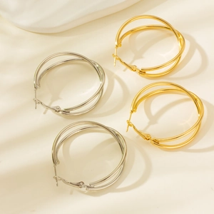 Detailed top view of gold and silver multi-layer crossover geometric hoop earrings