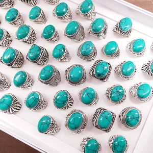 Macro view of vintage silver alloy rings with turquoise stones and ethnic engravings