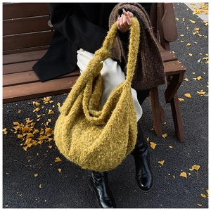 Detail of soft fuzzy texture on a large mustard green knit tote bag for autumn