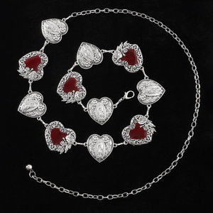 Silver heart waist chain with ruby red accents and Virgin Mary carvings on black background