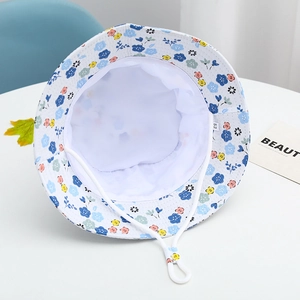 Detail view of cotton sun hat with floral pattern, adjustable drawstring and size 52 label