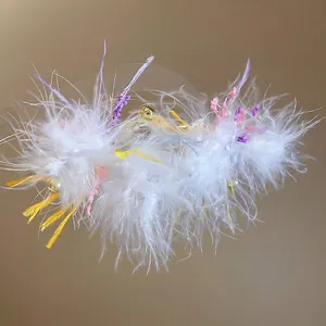Silver needle earrings featuring white feathers with colorful accents and gold bells