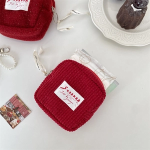 Detailed close-up of corduroy and fleece plush storage bags with zip and label