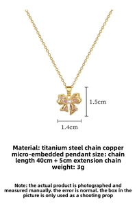 Detailed view of pink bow pendant with crystals, pearl drop and gold titanium steel chain