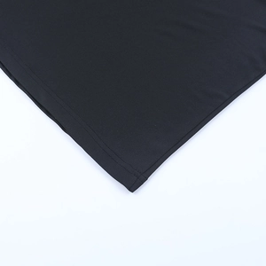 Detailed close-up of double-needle stitching on the hem of black sparkly A-line dress
