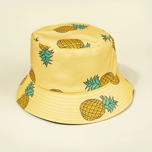 Close-up of yellow bucket hat with vibrant pineapple pattern and fine stitching detail