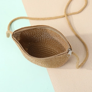 Close-up of the spacious interior and woven texture of this summer straw shell bag