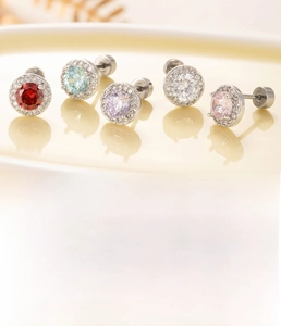 Detailed view of silver titanium steel cartilage studs with colorful zircon stones
