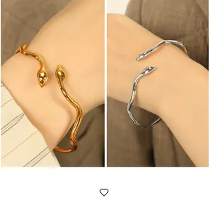 Detailed comparison of gold and silver snake-shaped wrap-around stainless steel cuffs