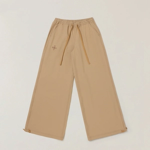 Detail of khaki wide-leg cargo pants with adjustable drawstring waist and cuffs