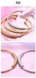 Detail of adjustable spring-style stainless steel cuffs in gold, silver, and rose gold