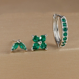 Macro shot of S925 silver earring set with emerald green crystals and petal shapes