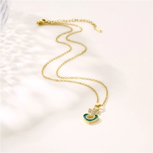 Gold necklace featuring heart pendant with green inlay, arrow detail and zircon stones