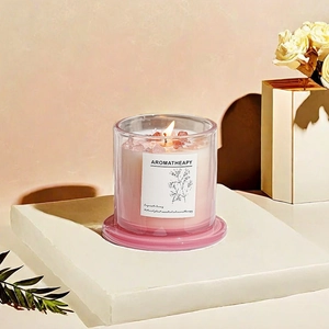 Pink aromatherapy soy candle in glass jar with crystal stones and floral background