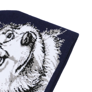 Close-up of the jacquard animal wolf pattern on a dark blue knitted winter beanie hat