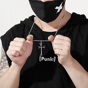 Close-up of a men's punk cross necklace crafted from bone-shaped titanium steel links