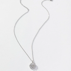 Elegant sunflower pendant necklace in silver with sparkling cubic zirconia on white background