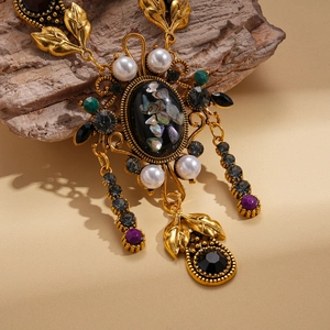 Close-up of vintage resin shell pendant necklace with antique gold leaf and colorful crystals