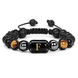 Close-up of handmade lava rock and tiger eye beaded bracelet with gold letter F charm