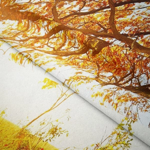 Close-up of vibrant autumn forest tapestry fabric showing detailed orange maple leaf prints