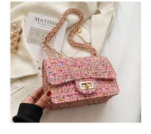 Close-up of pink tweed fabric texture and gold chain strap on an elegant crossbody bag