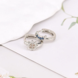 Detail view of S925 silver hoop earrings with sun and moon charms and colorful zircons