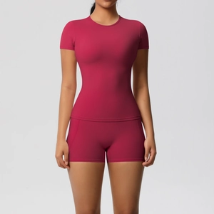Close-up of rose red short sleeve yoga top and high waist sports shorts in soft fabric