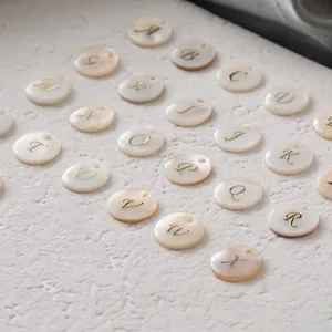Polished freshwater shell round alphabet pendants with gold letters for DIY jewelry making