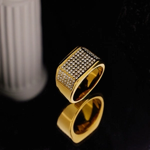 Macro detail of men's wide rectangle gold ring with white micro-pave crystals