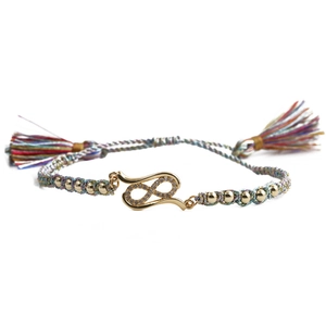 Detail of colorful braided rope bracelet with gold infinity symbol and white zircon stones