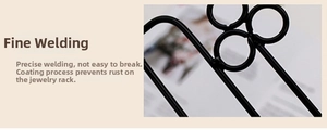 Detail of meticulous welding and black powder-coated finish on metal jewelry rack