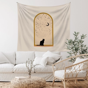 Detailed view of bohemian wall tapestry with cat and moon silhouette on fabric