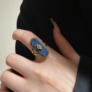 Detail of 18k gold plated stainless steel ring with blue lapis lazuli stone on model