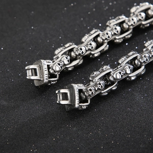 Close-up of vintage punk skull clasp on chunky stainless steel chain bracelet